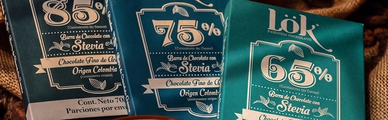 Three chocolate bars with teal packaging arranged side by side on a brown textured fabric background. The packages show percentages 85%, 75%, and 65% with the brand Lók visible on the rightmost bar.