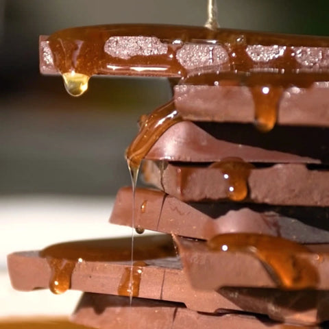 Stack of chocolate bars with honey dripping over them