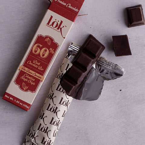 Dark chocolate bar with a Lök packaging on a gray surface